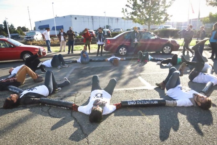 Citizens gathered outside the Northwest Detention Center in Tacoma in the dawn hours to blockade busses with deportees from leaving. (Photo by Angelica Chazaro)