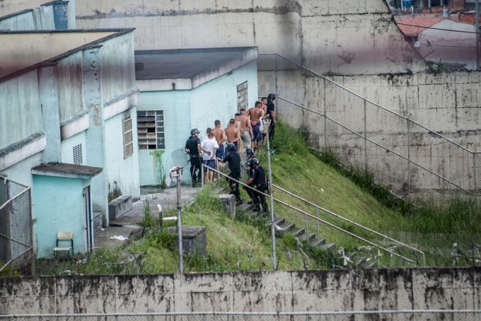 Underage prisoners in Fundação Casa, Brazil's juvenile prison system, are rounded up by police after taking over the São Paulo prison during a 2013 riot. (Photo by Marcelo Camargo / Agencia Brasil)