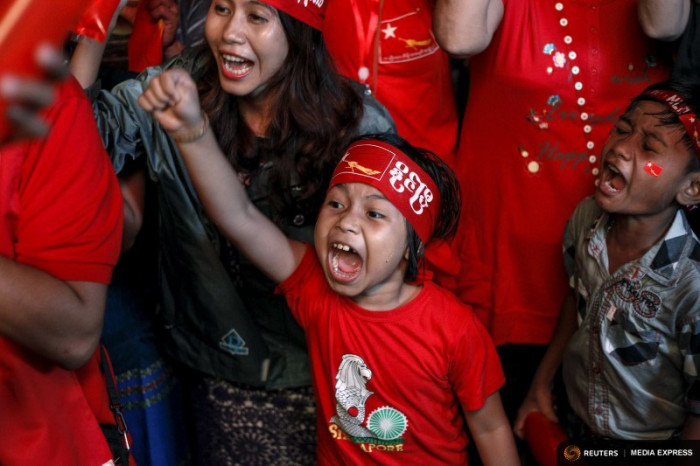 Supporters celebrate as they watch official results from the election in front of the National League for Democracy Party (NLD) head office in Yangon. (Photo by REUTERS/Soe Zeya Tun)