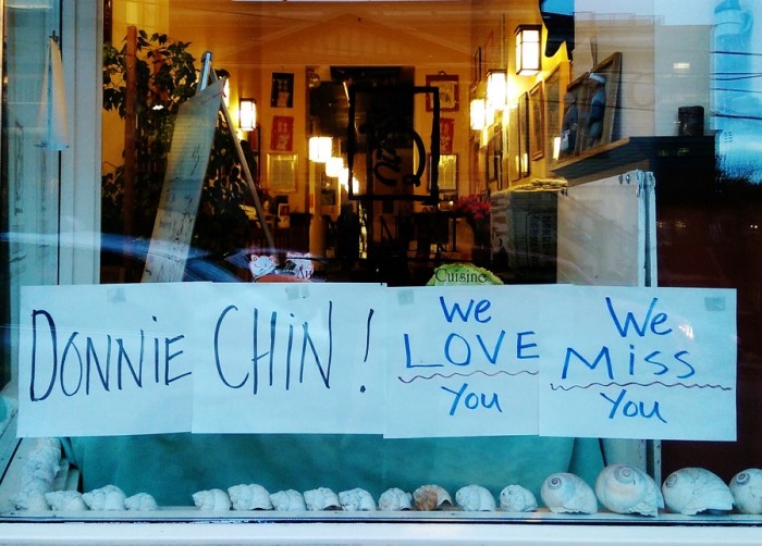 Maneki Restaurant, on Sixth Avenue South, pays tribute to Donnie Chin with a sign posted to the windowpane in the C-ID. (Photo by Sidney Sullivan)