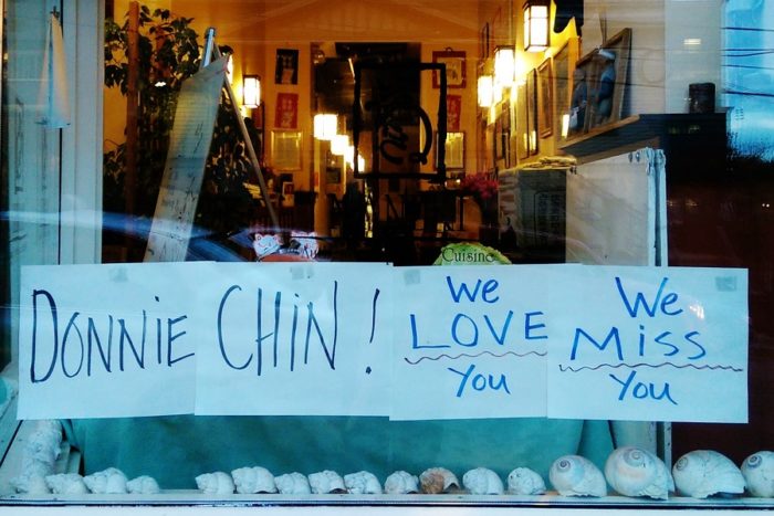 Maneki Japanese Restaurant, on Sixth Avenue South, pays tribute to Chin with a sign posted to the windowpane. (Photo by Sidney Sullivan)