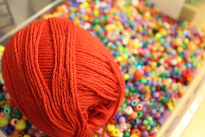 Yarn sits in a container of beads at the Chief Seattle Club’s art room. (Photo by Starla Sampaco)