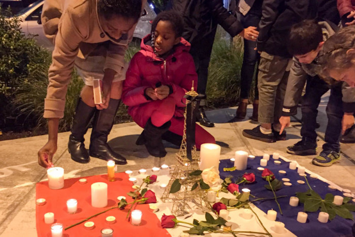 People gathered Sunday outside of Ines Patisserie in Capitol Hill in Seattle for a vigil honoring the victims of last week's attacks on Paris. (Photo by Megan Herndon.)