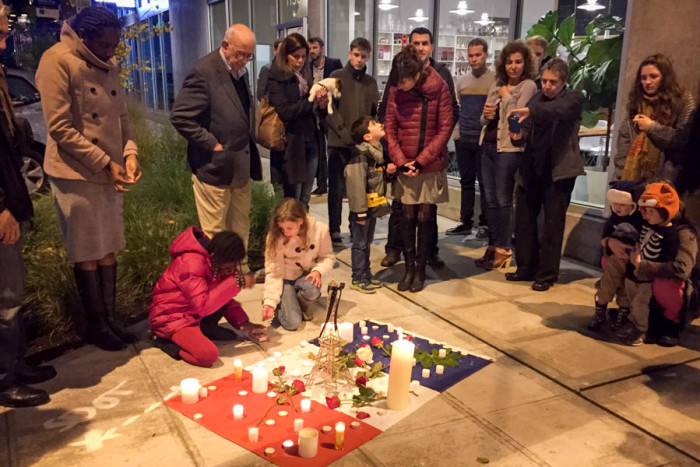 People gathered Sunday outside of Ines Patisserie in Capitol Hill in Seattle for a vigil honoring the victims of last week's attacks on Paris. (Photo by Megan Herndon.)