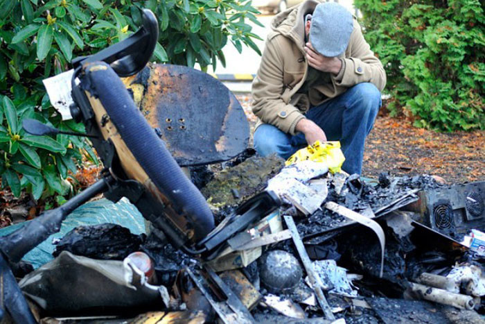 Ahson Saeed, of Corvallis, reacts to a pile of burnt debris pulled from the Salman Alfarisi Islamic Center in November 2010. (Photo by Jesse Skoubo for the Corvallis Gazette-Times.)