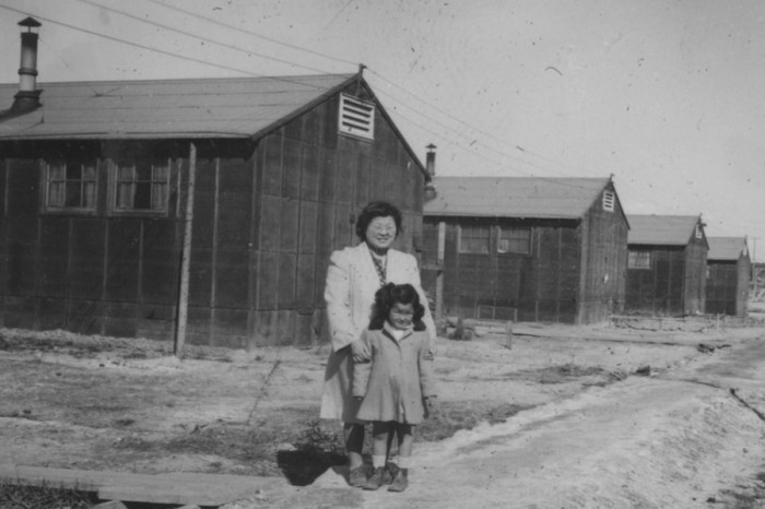 Mother and daughter near barracks at Minidoka Relocation Center in Idaho during World War II. (Archive photo courtesy Densho.)