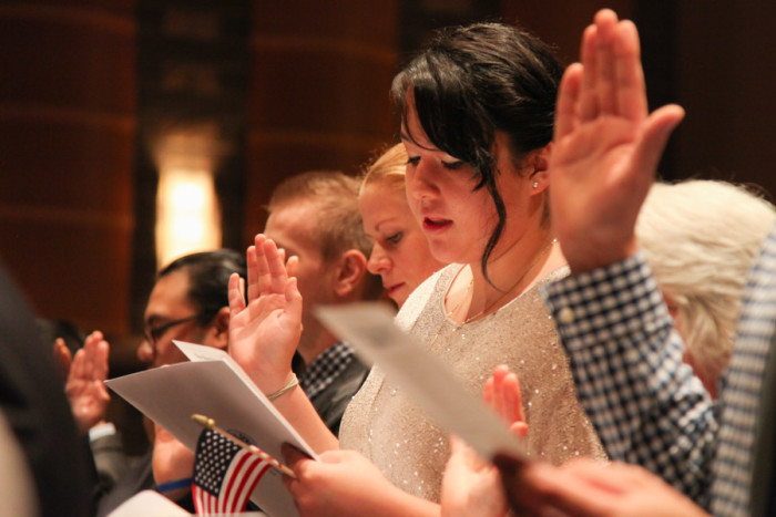 Liliana Caracoza takes the oath of citizenship at a ceremony in Tacoma in September 2014. (Photo by Alex Stonehill)