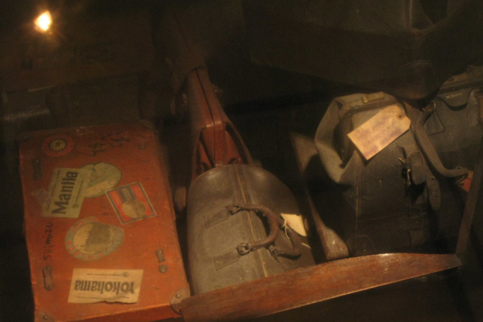 Luggage left behind by interned Japanese-Americans, on display through the floor of the Panama Hotel. (Photo by Sihanouk Mariona)