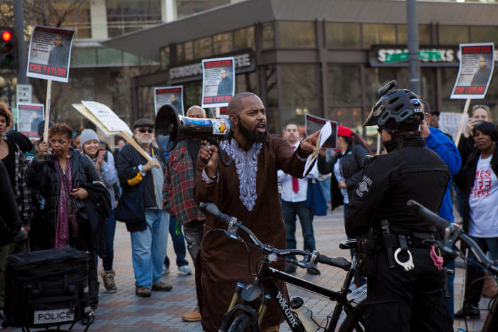 Andre Taylor asks Seattle police officers if they believe in justice for all people on February 25, 2016 at a demonstration for his brother, Che Taylor, who was shot and killed Sunday by Seattle Police. (Photo by Jovelle Tamayo.)