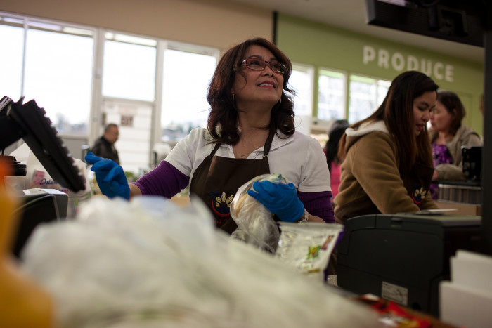 Susan Caberto rings up a customer’s purchases on February 24, 2016 at Island Pacific Market, a Filipino-inspired grocery store in Seattle’s Rainier Valley. (Photo by Jovelle Tamayo.)