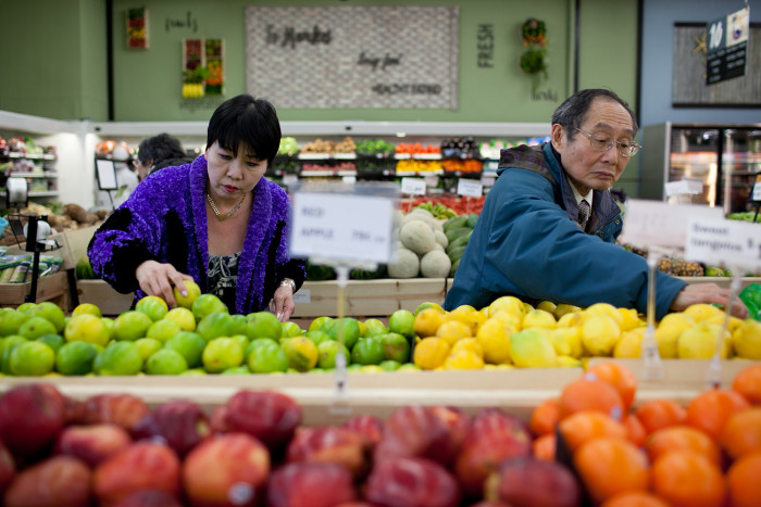 Shoppers choose fruit at Island Pacific Market, a Filipino-inspired grocery store in Seattle’s Rainier Valley. (Photo by Jovelle Tamayo.)