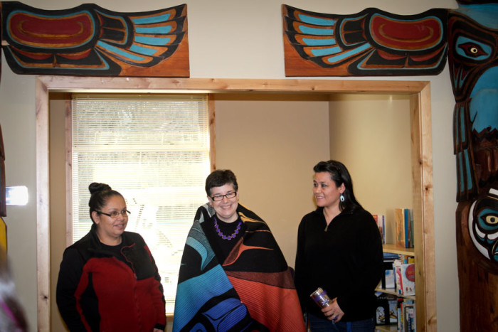 UW president Ana Mari Cuace is presented with an honorary blanket by Lummi tribal member Luanne Wilson. (Photo by Sharayah Lane)