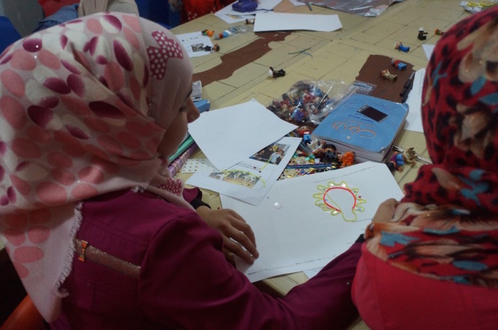 Teens work on their Magic Genius Device designs during a workshop at Za'atari Refugee Camp in Jordan in November 2015. (Photo courtesy of Brian Tomaszewski, Rochester Institute of Technology)
