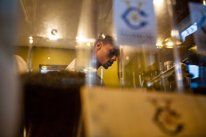  Solomon Dubie, owner of Café Avole in Southeast Seattle, makes a latte on Friday, March 11, 2016, the day before his grand opening celebration. (Photo by Jovelle Tamayo.)