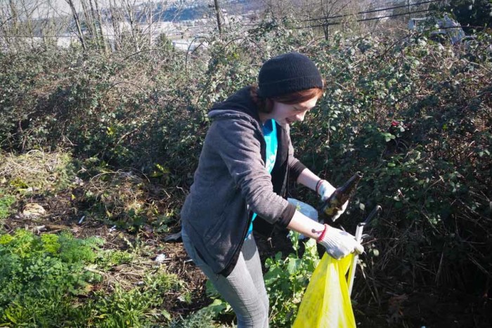 James Suggs picking up litter as part of the Duwamish Valley Youth Corps program. (Photo by Barbara Clabots)