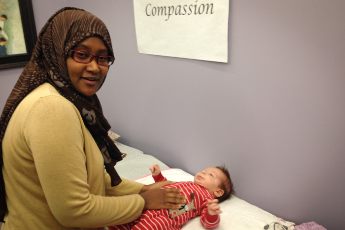 Midwife Faisa Farole examines Malcolm Stonehill (the author's son) at the new Rainier Valley Community Clinic, which offers culturally competent pre- and postnatal health care. (Photo by Sarah Stuteville)