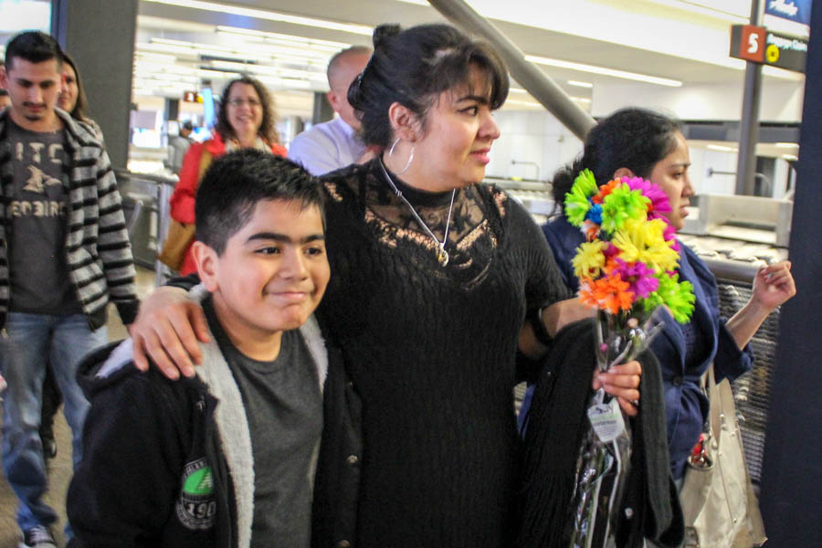 Nestora Salgado (center) puts her arm around her grandson Cristian, at Seattle-Tacoma International Airport as she returns from Mexico after kidnapping charges against her were dropped. (Photo by Venice Buhain).