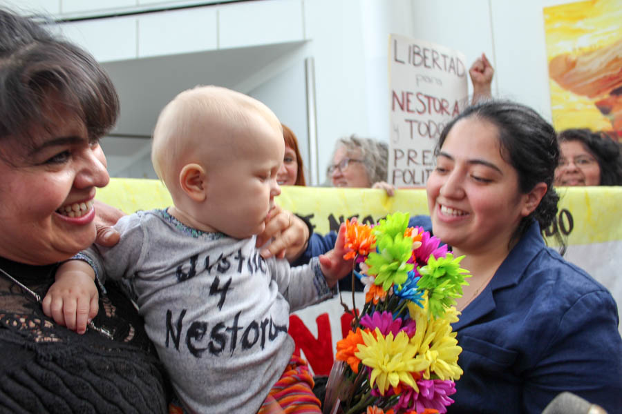 Nestora Salgado (left) and her daughter Gris Rodriguez (right) hold 13-month-old Marigold Stokes, the baby of supporter Iris Stokes, as Salgado returned to Seattle on Tuesday. (Photo by Venice Buhain.)