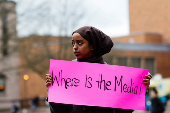 Vigil organizer Nafiso Egal, sophomore, holds a sign that reads, "Where is the media?" UW Students call for attention to the lives and deaths of the black Muslims. (Photo by Raisa Janjua)