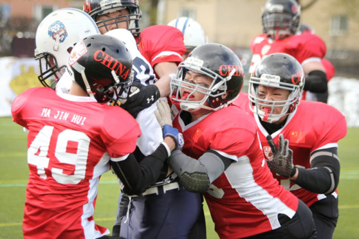 Chinese players take on Finland in the first American Football World University championship in 2014. (Photo from Youtube)