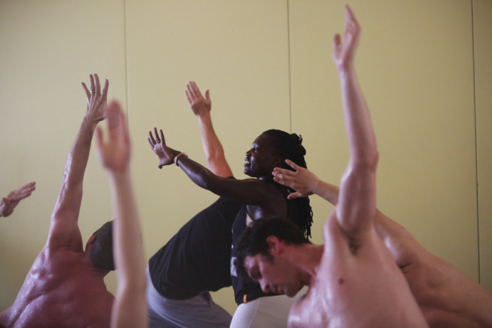 Irene Auma, seen helping conduct a yoga class in Seattle, grew up in a Nairobi slum and came to yoga through a program called the "Africa Yoga Project." (Photo by Ken Lambert / The Seattle Times)