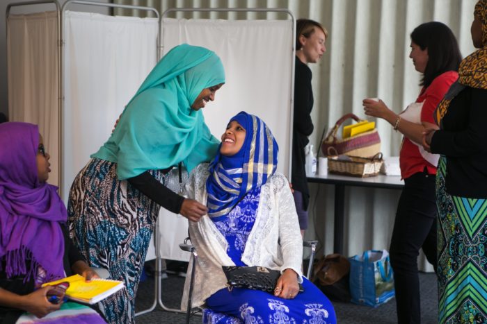Nurse Geni Sheikh gives a hug to Roda Mahamoud, expecting her first baby, during the Somali CenteringPregnancy program at the Neighborcare Health clinic in Columbia City. (Photo by Bettina Hansen for the Seattle Times)