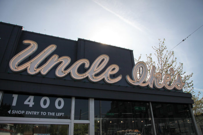 Uncle Ike's in the Central District has pushed laws that limit pot stores to one 1,600-square-inch sign by putting larger neon signs on its paraphernalia shop next door, and on a mural next to the shop. (Photo by Alex Stonehill) 