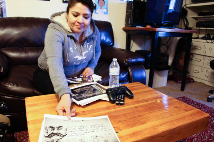 Nestora Salgado in her Renton home showing a political cartoon featuring her court case. Her incarceration became a cause celebre in Mexico. (Photo by Venice Buhain.)
