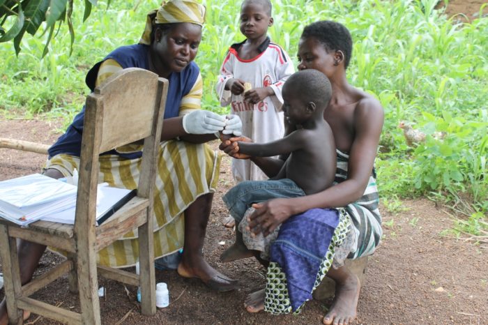 A community health worker with a mom and her child in Togo. (Photo courtesy 30/30 Project.)