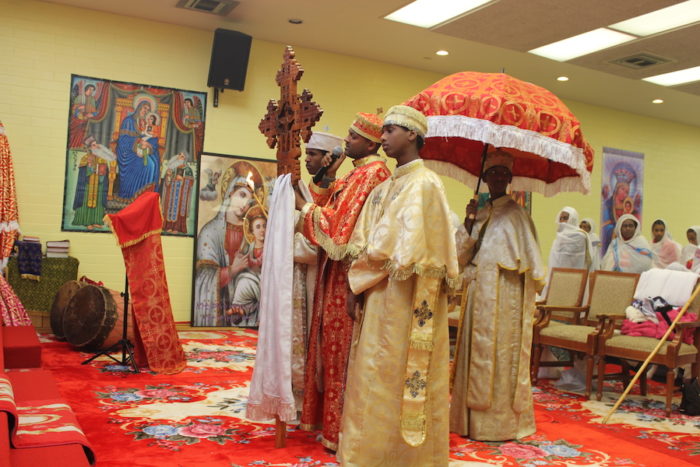 Archdeacon of the Mass team singing the Psalm of the day at the Ethiopian Orthodox Tewahedo Church's new space in Skyway. (Photo by Goorish Wibneh.) 