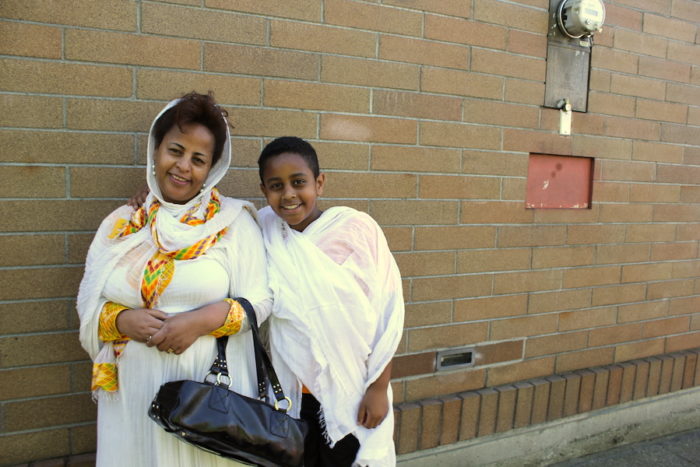 Hirut Dube with son after the end of Mass. (Photo by Goorish Wibneh.)