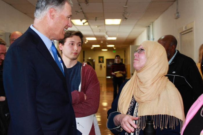 Gov. Jay Inslee speaks with Janice Tufte, of the Islamic Civic Engagement Project and Muslims Vote, after a press conference. (Photo by Venice Buhain.)