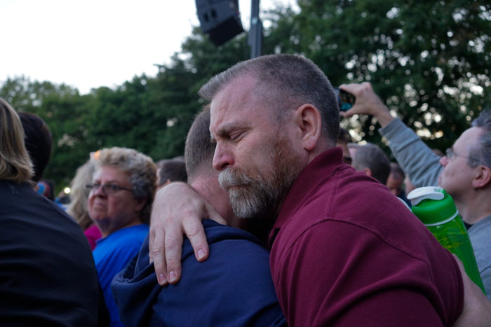 Mourners hug at a gathering at Cal Anderson Park on Sunday to commemorate the victims of a mass shooting at a nightclub in Orlando. (Photo by Chloe Collyer.)