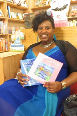 Reagan Jackson poses with her "Coco LaSwish" childrens' books. Jackson will perform a reading of her books at the new Third Place Books in Seward Park on July 9. (Photo by Samantha Pak)