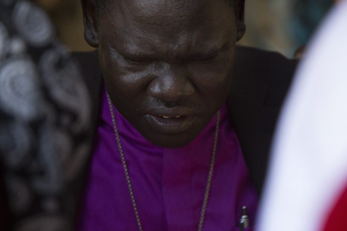 Bishop Kuol leads a prayer with homeless South Sudanese refugees living in the Jungle. (Photo by Sy Beam / The Seattle Times)