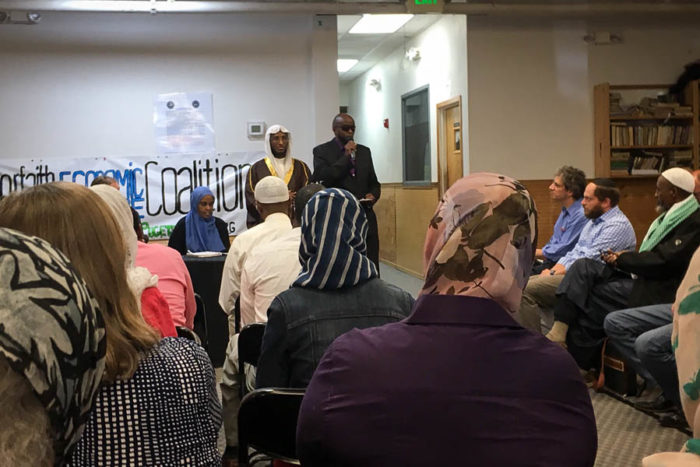 Imam Ahmed Nur, with a translator, welcomes the crowd to the the Abu Bakr Islamic Center. (Photo by Venice Buhain)