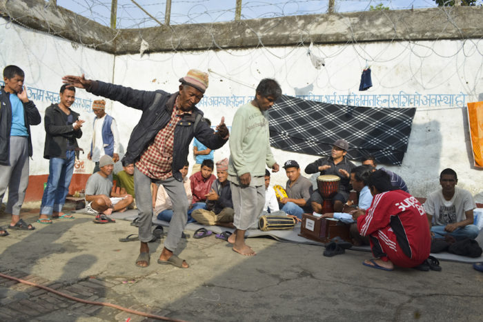 Prisoners dance and sing in the compound each morning within Kavre District Prison. Instruments are donated, and prisoners take turns playing them and singing. Prison officials say this type of activity helps prisoners manage depression. (Photo by Kalpana Khanal for GPJ Nepal)