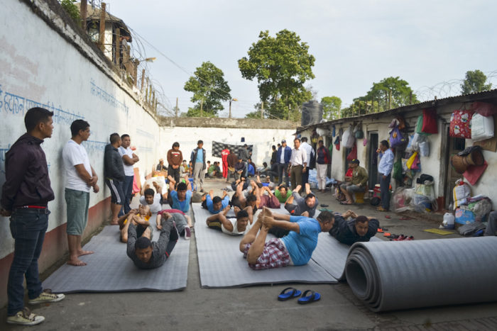 Caption: Prisoners practice yoga at Kavre District Prison. The class, taught by prisoners with yoga experience, is held each morning. (Photo by Kalpana Khanal for GPJ Nepal)