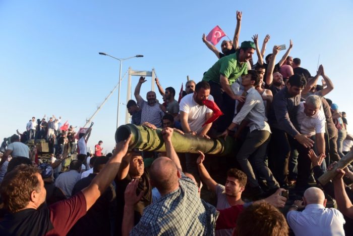 Supporters of Tukish President Tayyip Erdogan celebrate after soldiers involved in the coup surrendered on the Bosphorus Bridge in Istanbul, Turkey July 16, 2016. (Photo by Yagiz Karahan for Reuters)