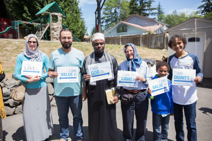 Seattle-area Quakers, pictured here with mosque attendees, formed a show of support at the Islamic Center of Federal Way, to show solidarity at the final Jummah of Ramadan. (Photo by Alex Garland.)