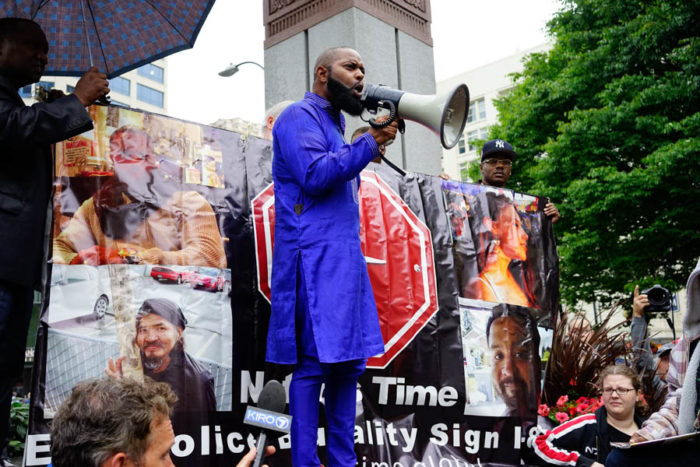 Andre Taylor, co-director of Not This Time, speaks passionately as the crowd assembles. His brother Che Taylor was killed by Seattle police earlier this year. (Photo by Chloe Collyer)