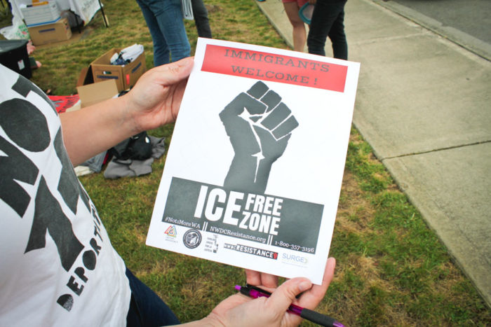 Immigration reform activist Maru Mora Villalpando holds a flier outside the NWDC. (Photo by Damme Getachew)