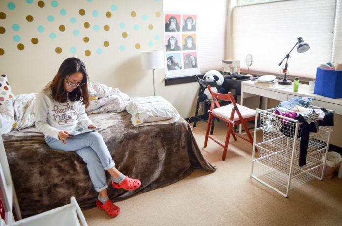 Sylvia Zhao, 22, sits in her newly rented room in a townhouse owned by a fellow Chinese international student in Lake City. (Photo by Katherine Jinyi Li)