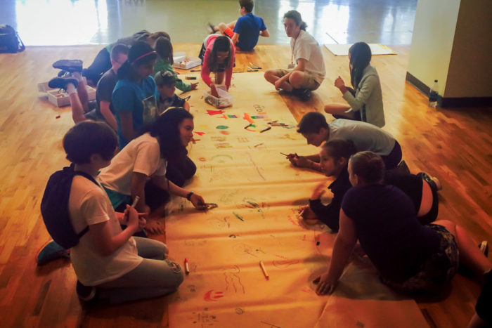 Working on a mural at the Kids4Peace camp. (Photo by Ahlaam Ibraahim)