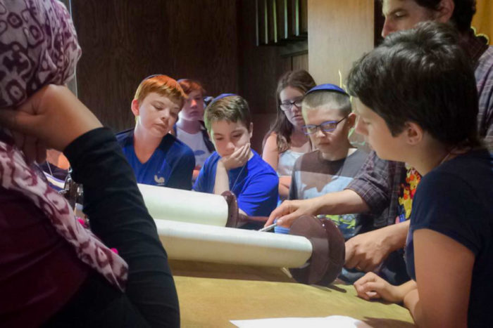 Participants in the Kids4Peace summer day camp look at the Torah at Herzu Ner-Tamid Synagogue on Mercer Island. (Photo by Ahlaam Ibraahim)