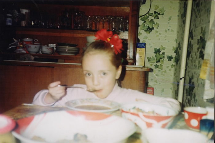 The author at age 7 in the kitchen of her apartment, eating lunch. (Photo courtesy of Daria Kroupoderova) 