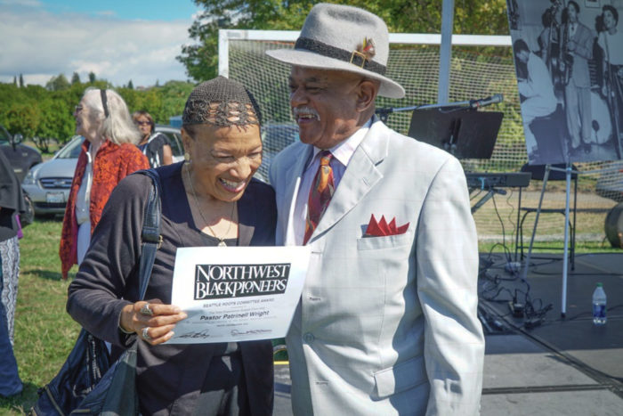 Pastor Patrinell Wright laughs with Blues singer Johnnie Moore, right, after Wright and the Total Experience Gospel Choir performed at the ROOTS picnic. (Photo by Susan Fried)