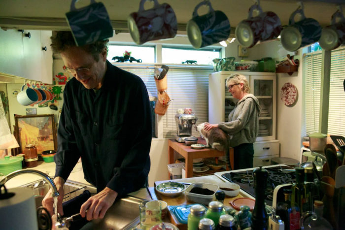 Jeff Holtzman and Jill Haas talk in their kitchen at University Trailer Park. They're reluctant to leave the 500- square-foot-home and are looking for a new trailer in Olympia. (Photo by Erika Schultz / The Seattle Times)