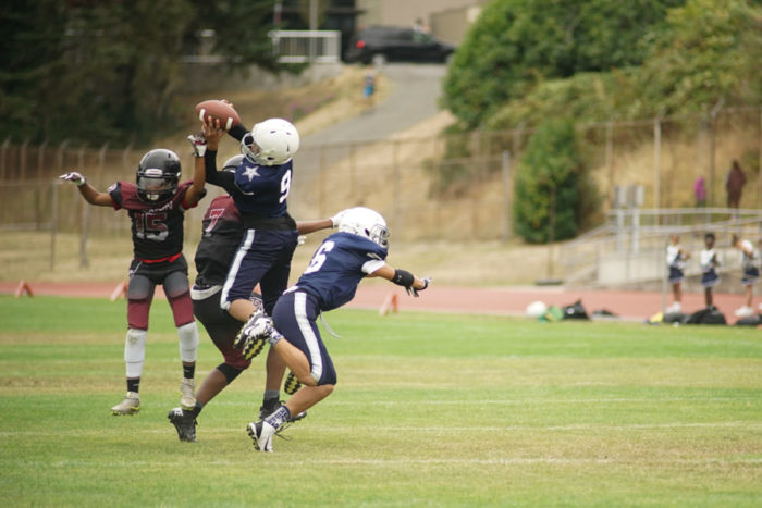 A Beacon Hill Cowboy receiver makes an athletic catch in their opening game against the Renton Rangers Senior squad.