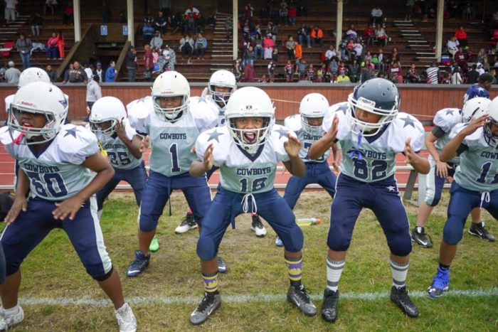 Beacon Hill Cowboy Junior Jarel Craig (center) and his teammates warm up before their game against the Renton Rangers. (Photo by Susan Fried)
